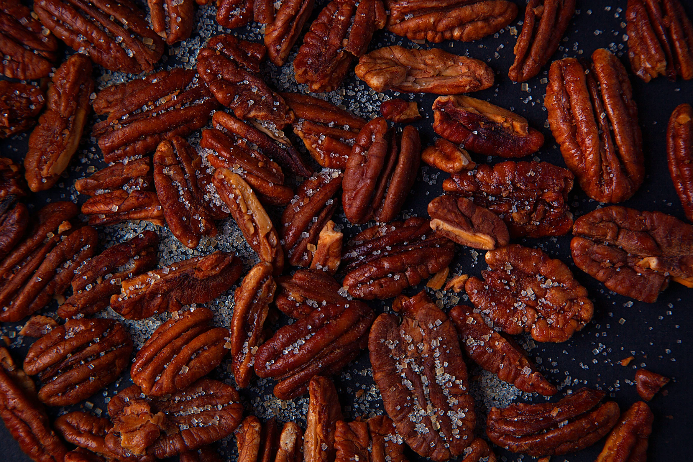 nuts are on a baking pan that has powdered sugar