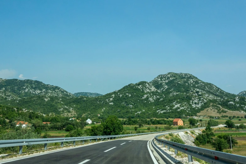 a freeway with two lanes leads into the mountains