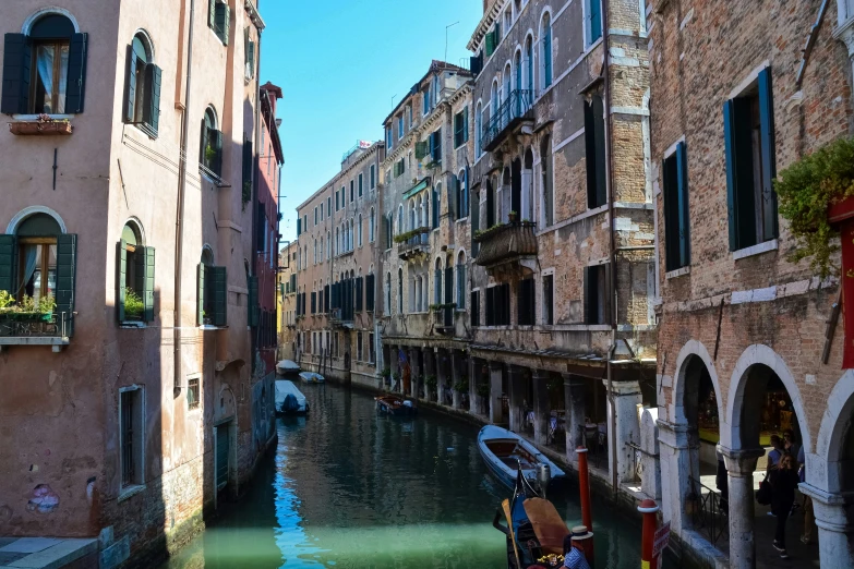 the building are all along the river and the boats