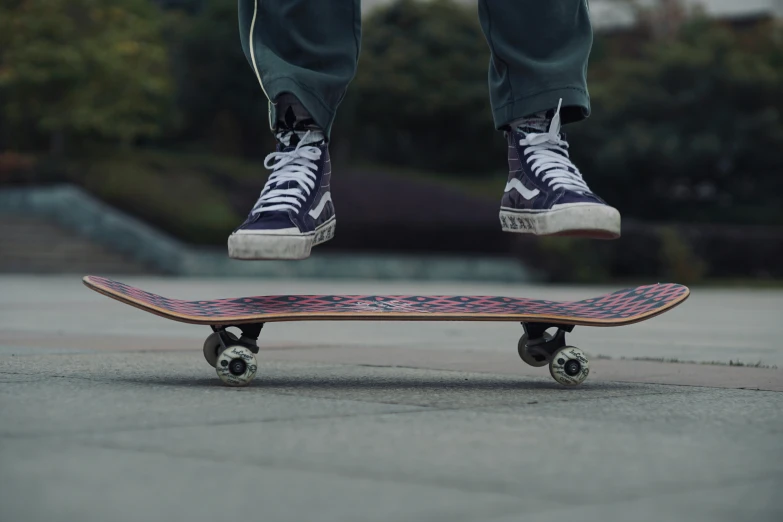 the feet and legs of a person riding on a skateboard