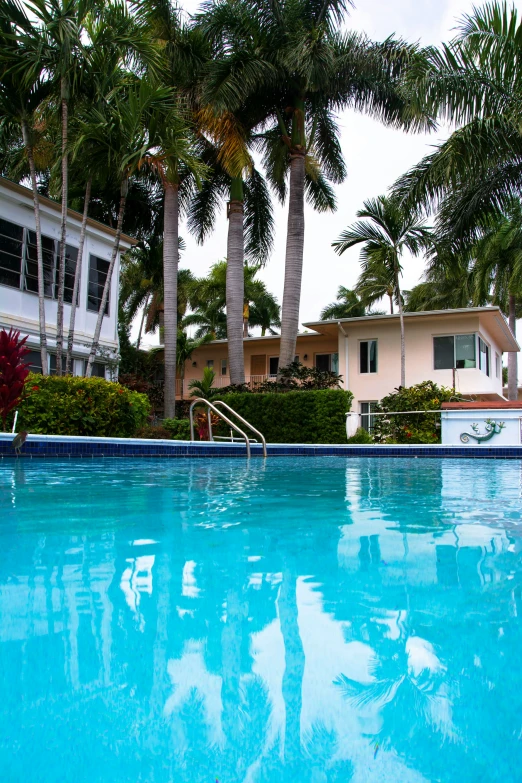 large pool with a resort in the back