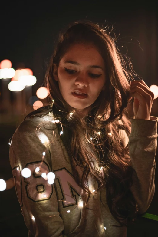 a girl looks on as she holds her ear while she poses for a po