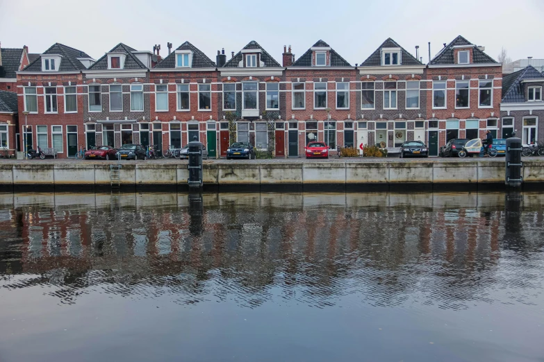 a row of old brick buildings along the side of a river