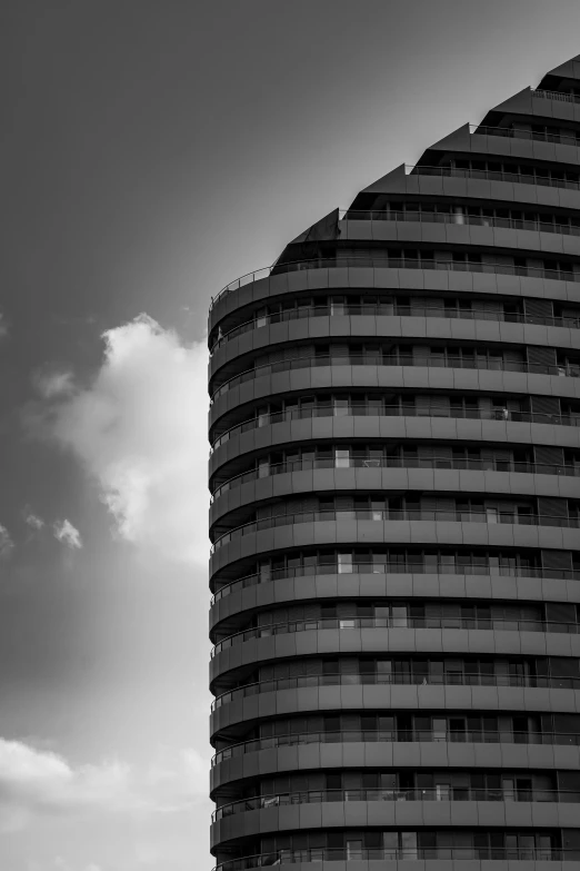 an airplane flying by the top of a high building