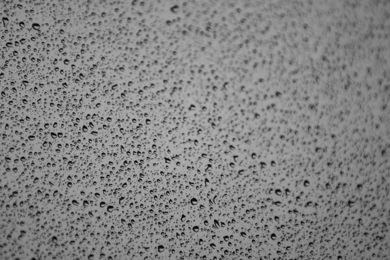 drops of water on the surface of a surface with a black and white background