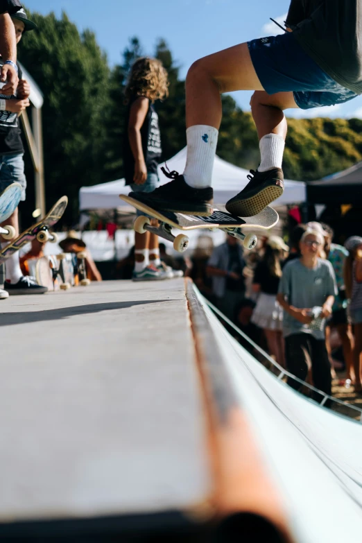 someone in mid air on a skateboard while others look on