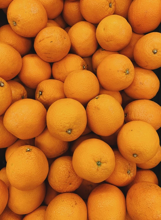 a pile of oranges that are on display