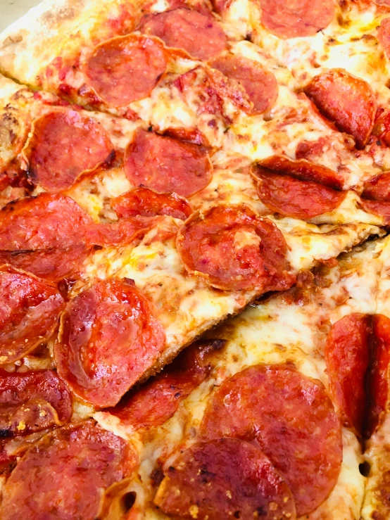 a sliced pepperoni pizza with cheese is shown