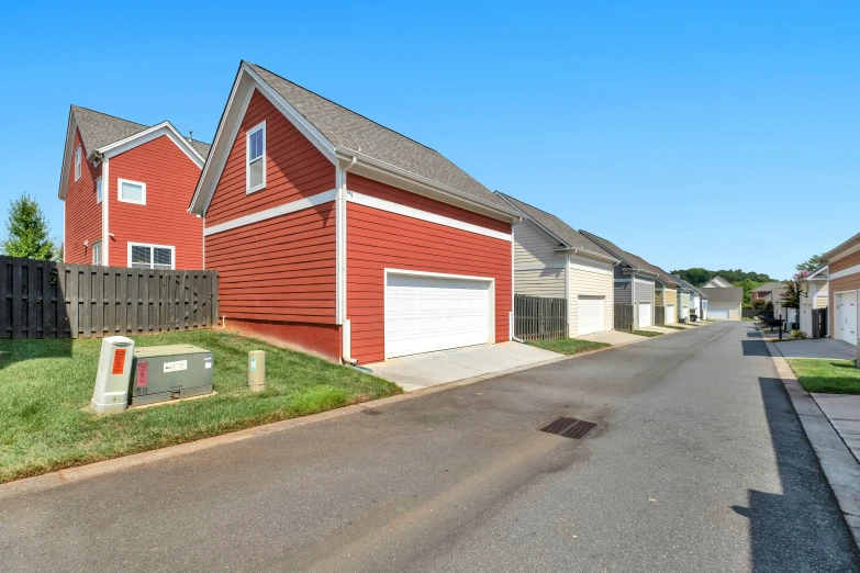 a brick house with two garages next to a street