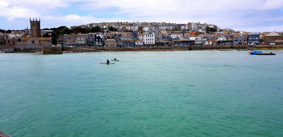 a person riding on the back of a surfboard in a body of water