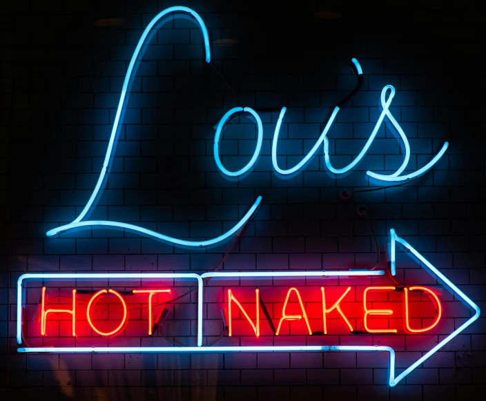 a neon sign on a wall with a neon inscription