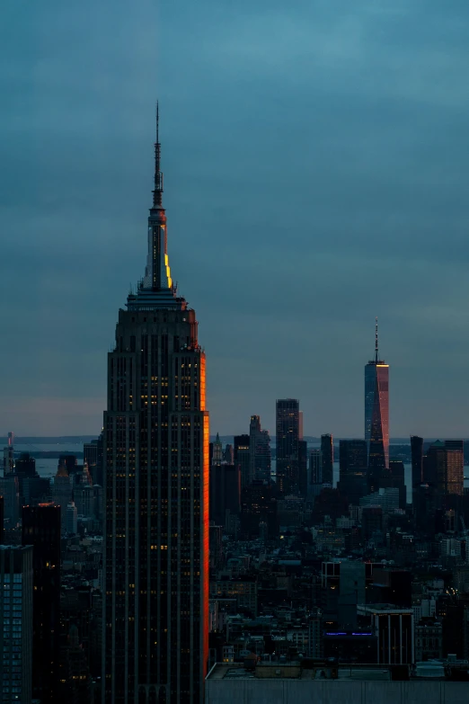 the city is lit up at night in the distance