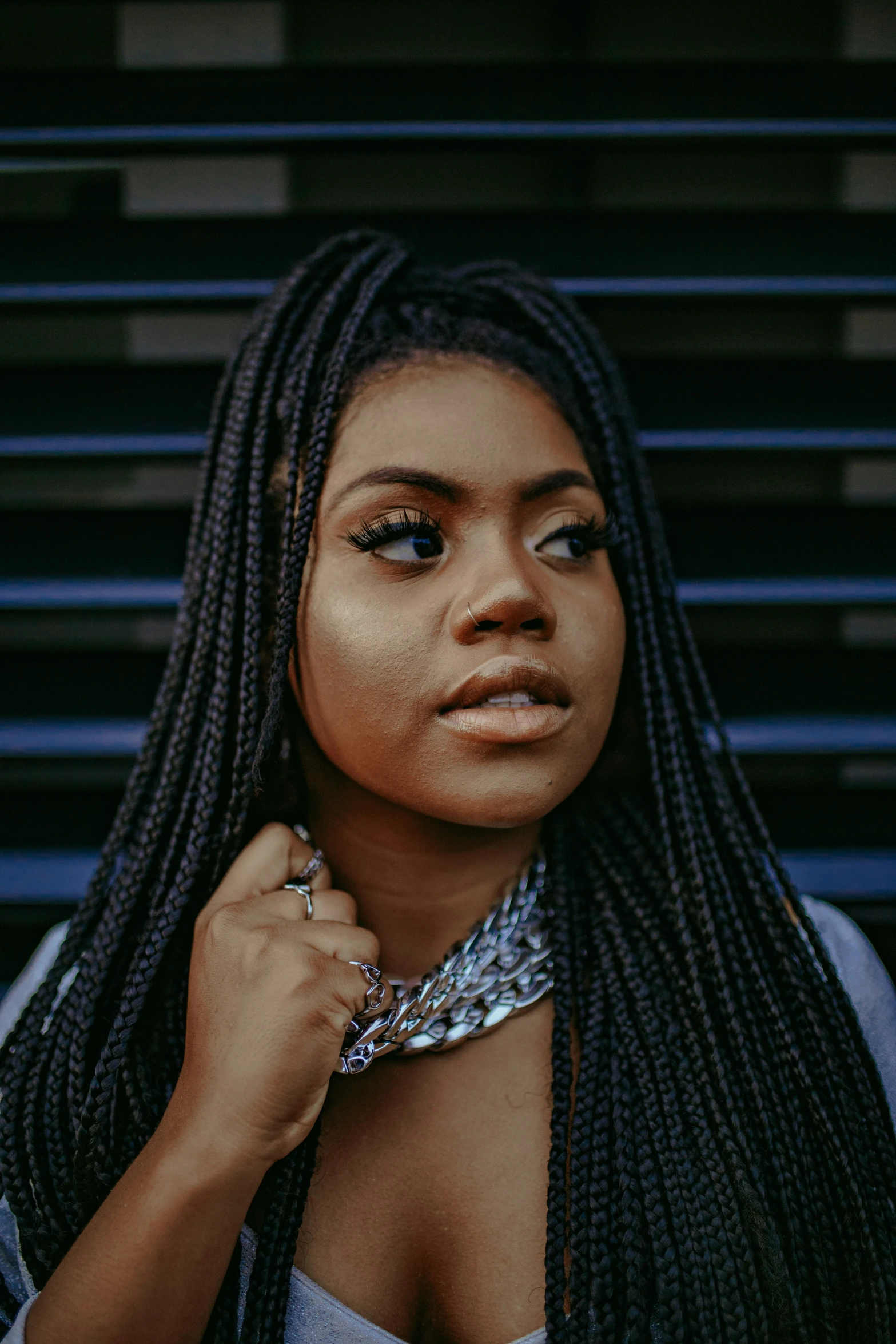 black woman with long locks is standing outside