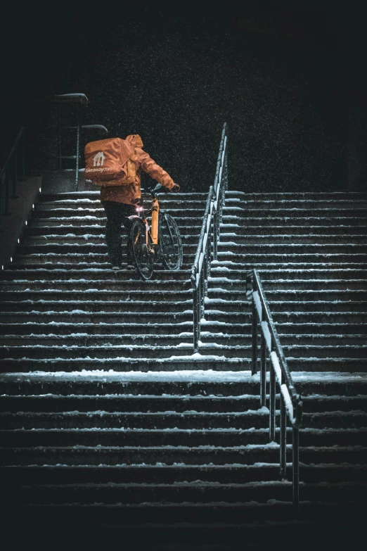 a man on his bike at the stadium in the snow