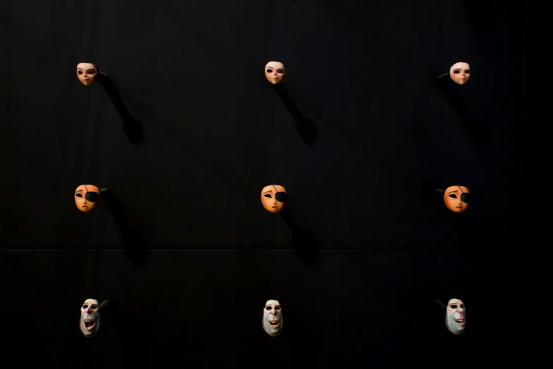 the wall is lined with different masks to show off on it