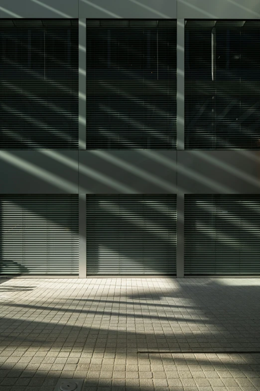 a skateboarder rides on the sidewalk near a closed metal door