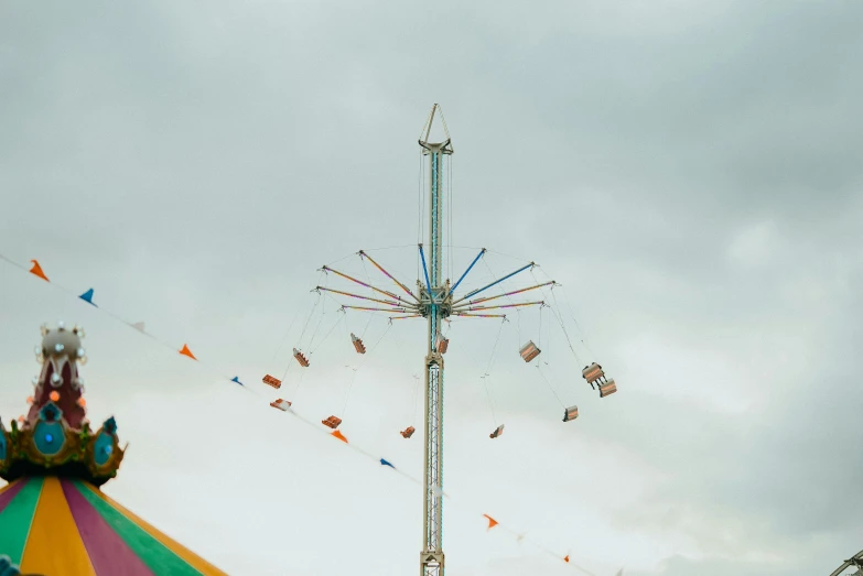 carnival rides are shown in front of an overcast sky