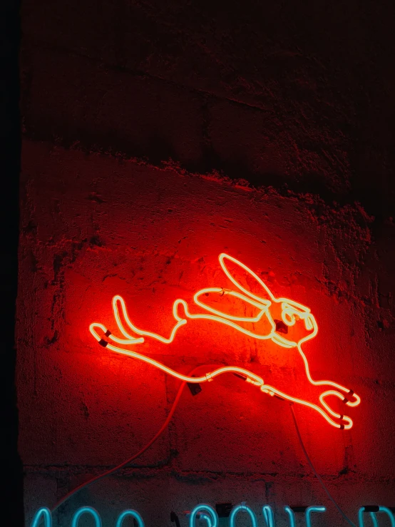 a neon sign for a cafe on a brick wall