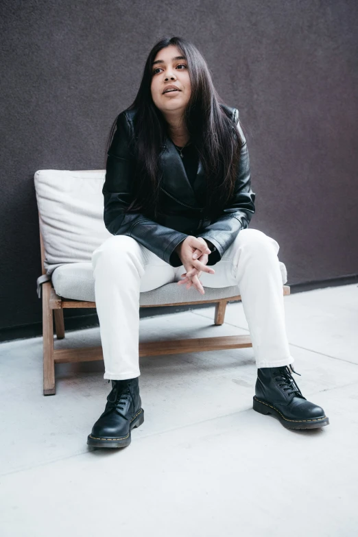 an asian girl sitting on top of a white couch