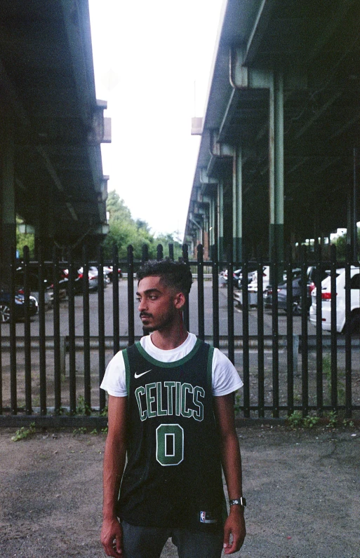 a man standing with a basketball on a city street