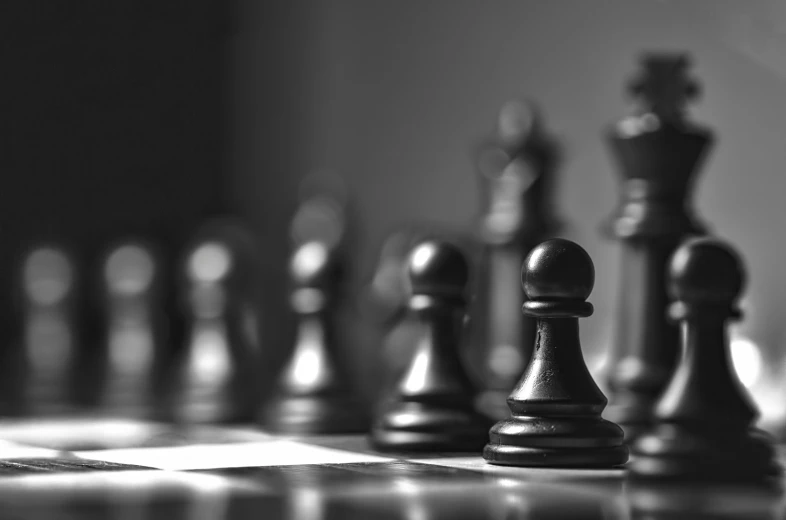 a set of chess pieces sitting on top of a table