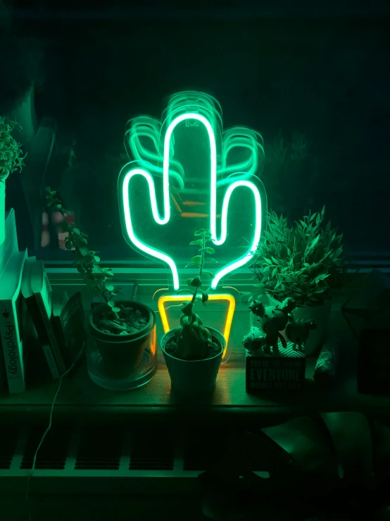 a green lit up cactus sitting on a table