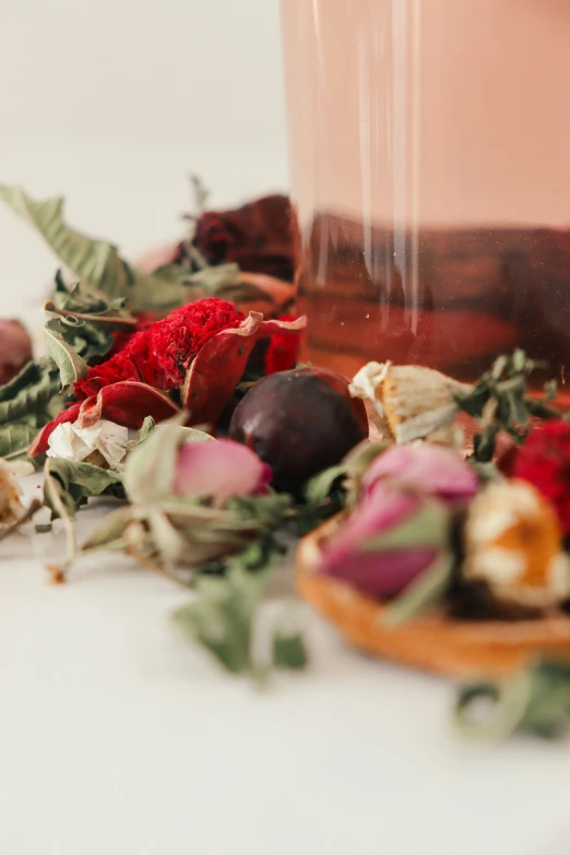 an empty glass bottle with some dried vegetables on it