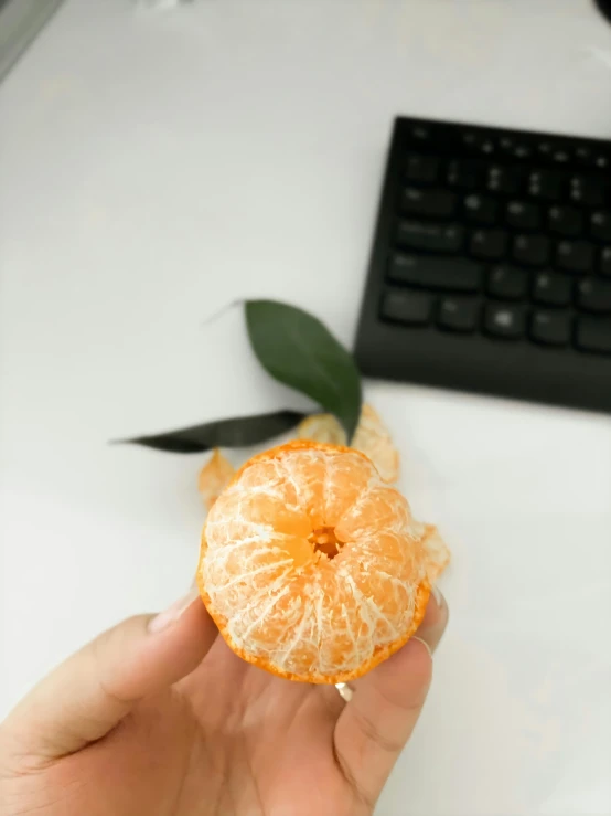 an orange that has been peeled and sitting in someones hand