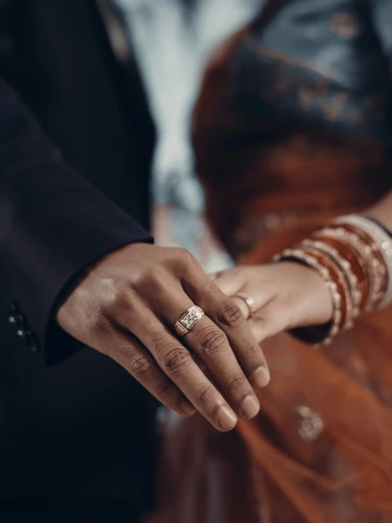 the groom and bride are holding each other's hand