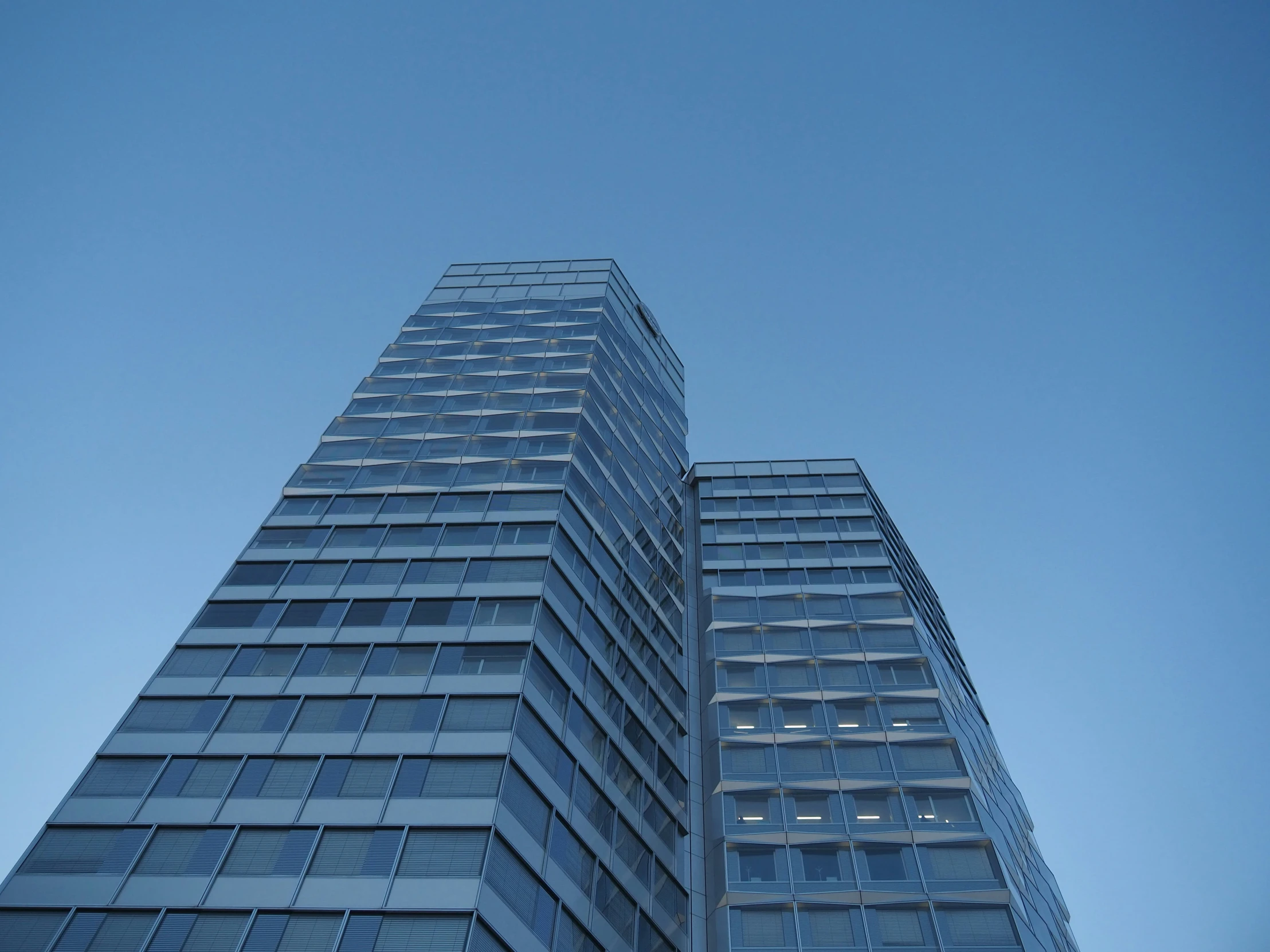 a tall skyscr has very blue glass windows