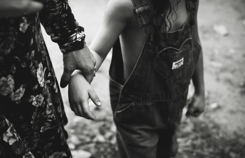 black and white pograph of people holding hands