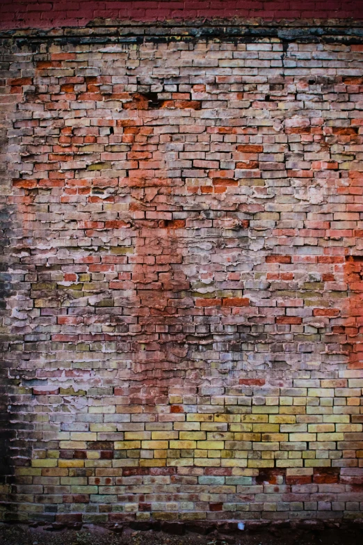an old painted brick wall with a fire hydrant