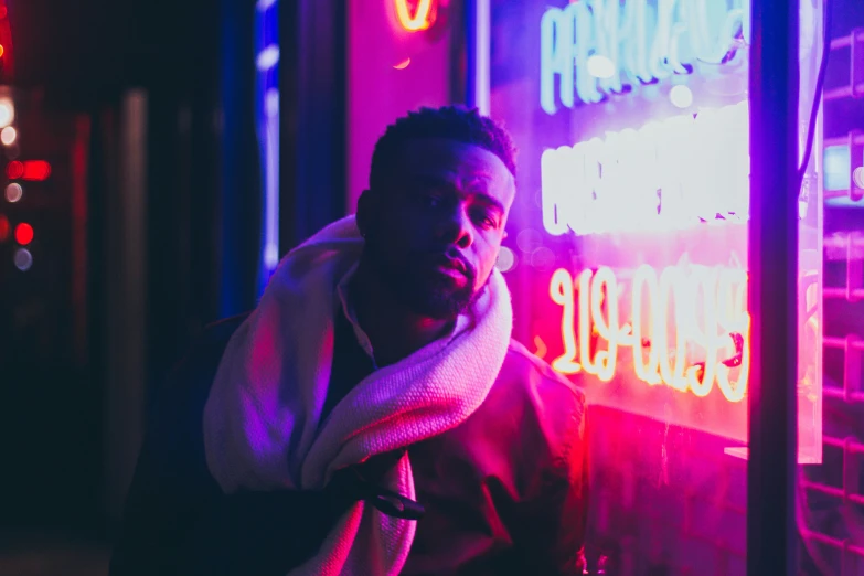 a man in a jacket is sitting outside at night