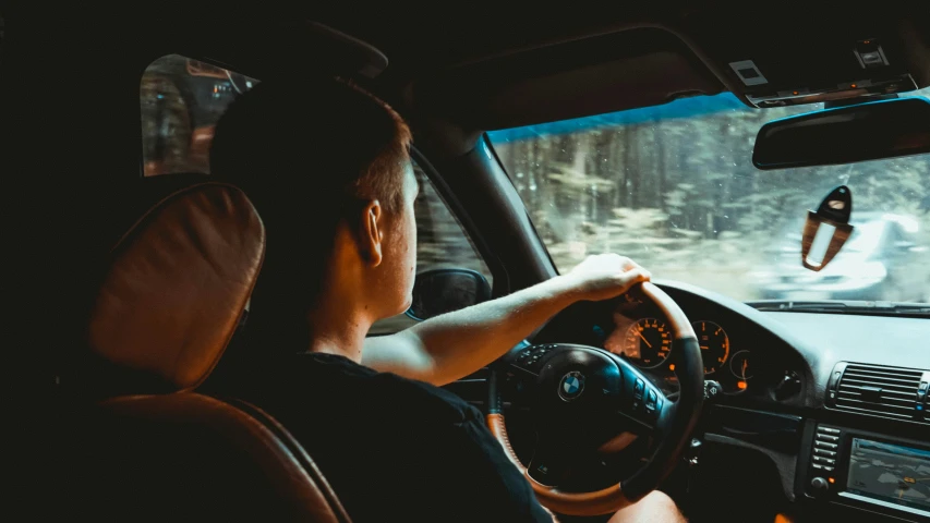 a man driving in his car at night