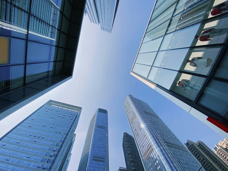 a view up at tall buildings looking into the sky