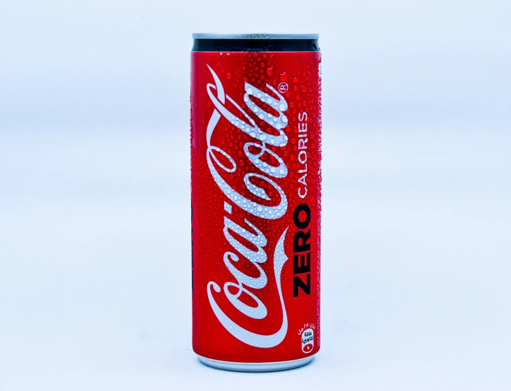 a can of coke coca cola sitting on top of a white counter