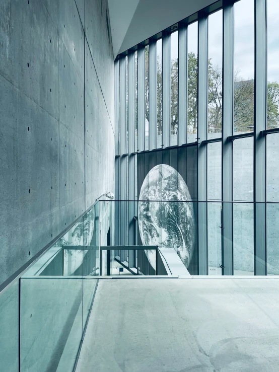 an indoor space with glass and concrete walls