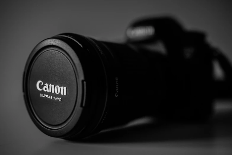 a canon camera lens cap is shown in black and white