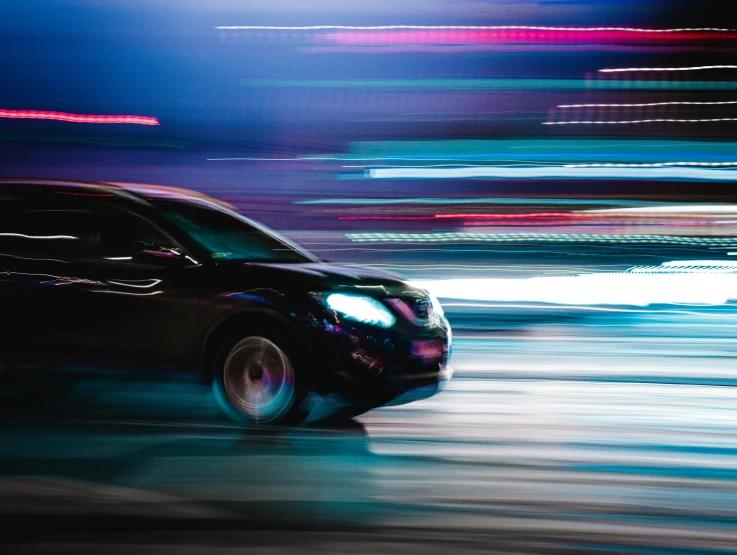 a picture of a car on a street at night