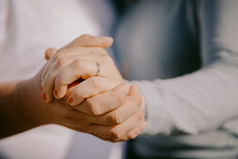 an image of two people holding hands