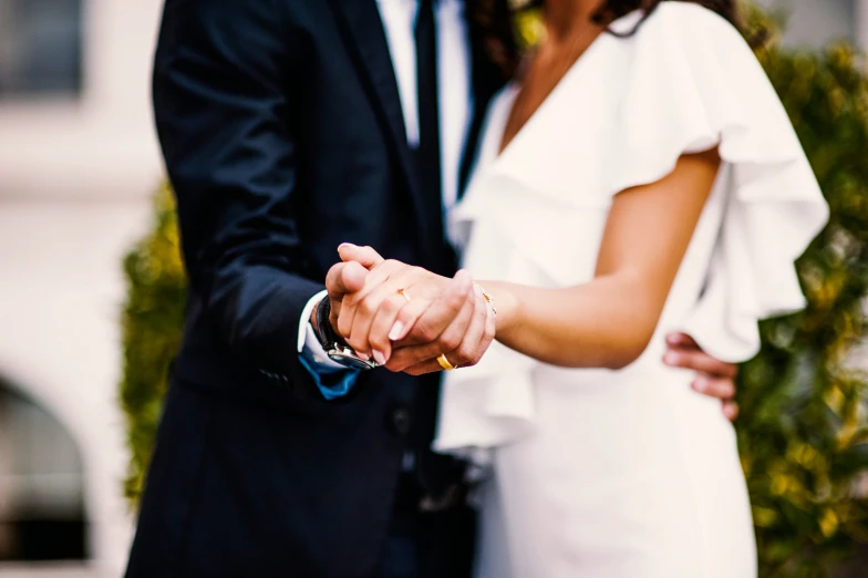 the bride and groom are posing with each other