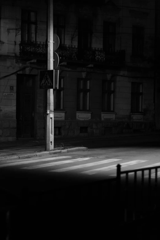 a tall clock tower next to a city street at night