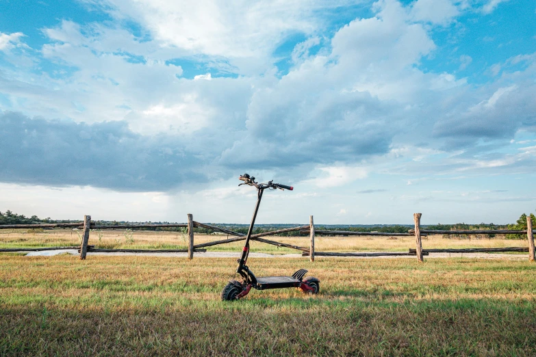 a scooter sitting in the middle of a field