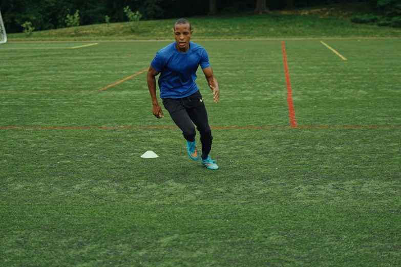 a man is playing soccer on the grass