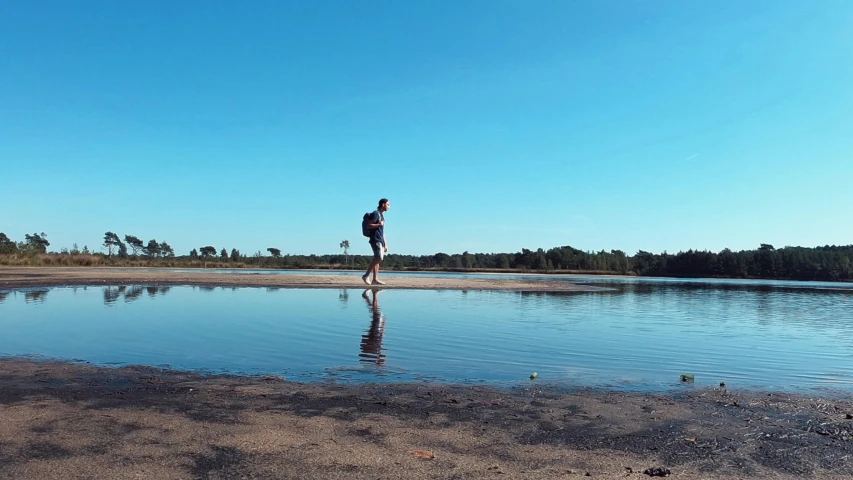 there is a man standing on the shore line