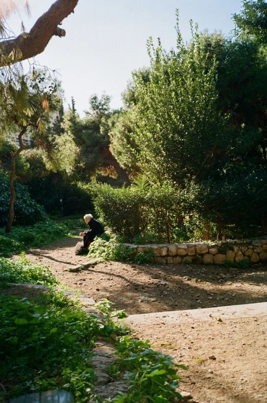 a man sits on the ground looking at soing