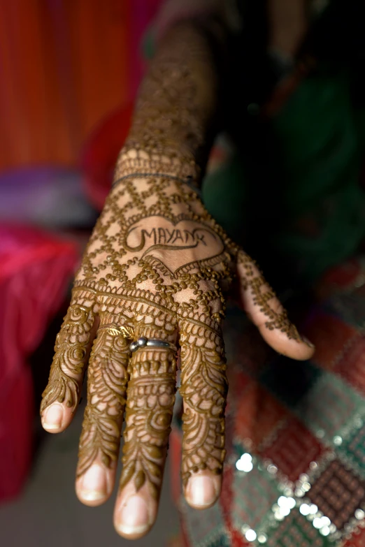 a woman is showing off her henna