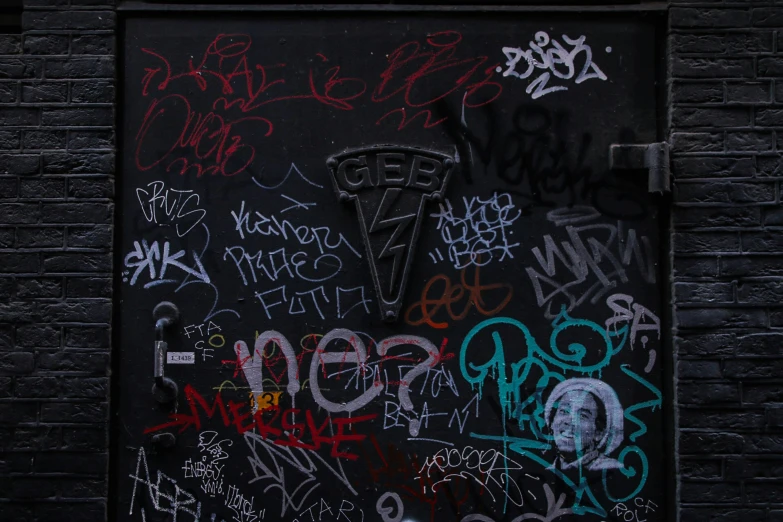 a doorway is covered in graffiti and other graffiti