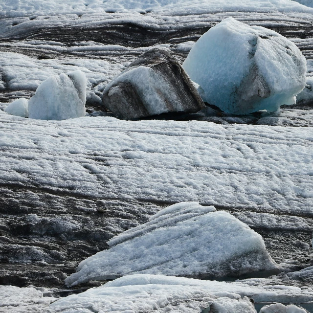 the snow covered rocks are on the water