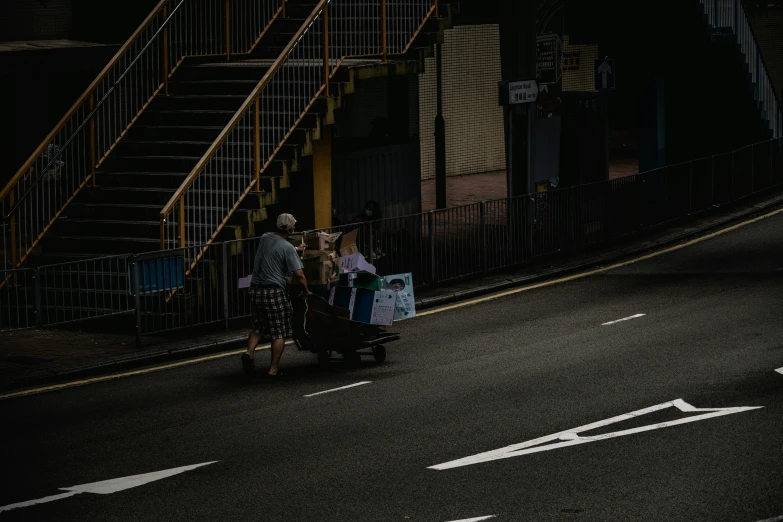 there are people walking down the road under a stairwell